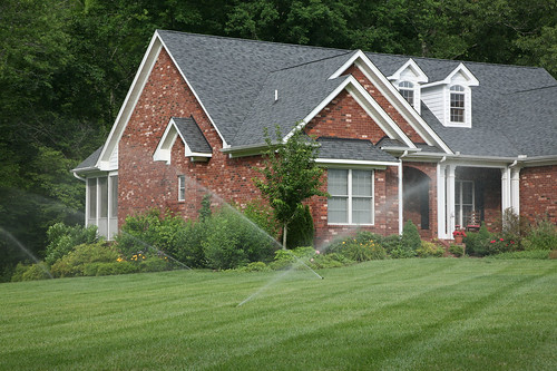 Freshly curated and mowed lawn with house in background - Thumbz Up Property Services LLC